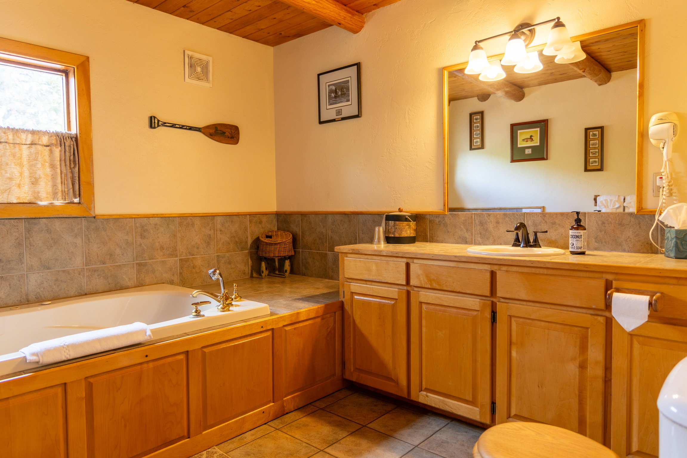 Classic bathroom with soaking tub and wood cabinetry