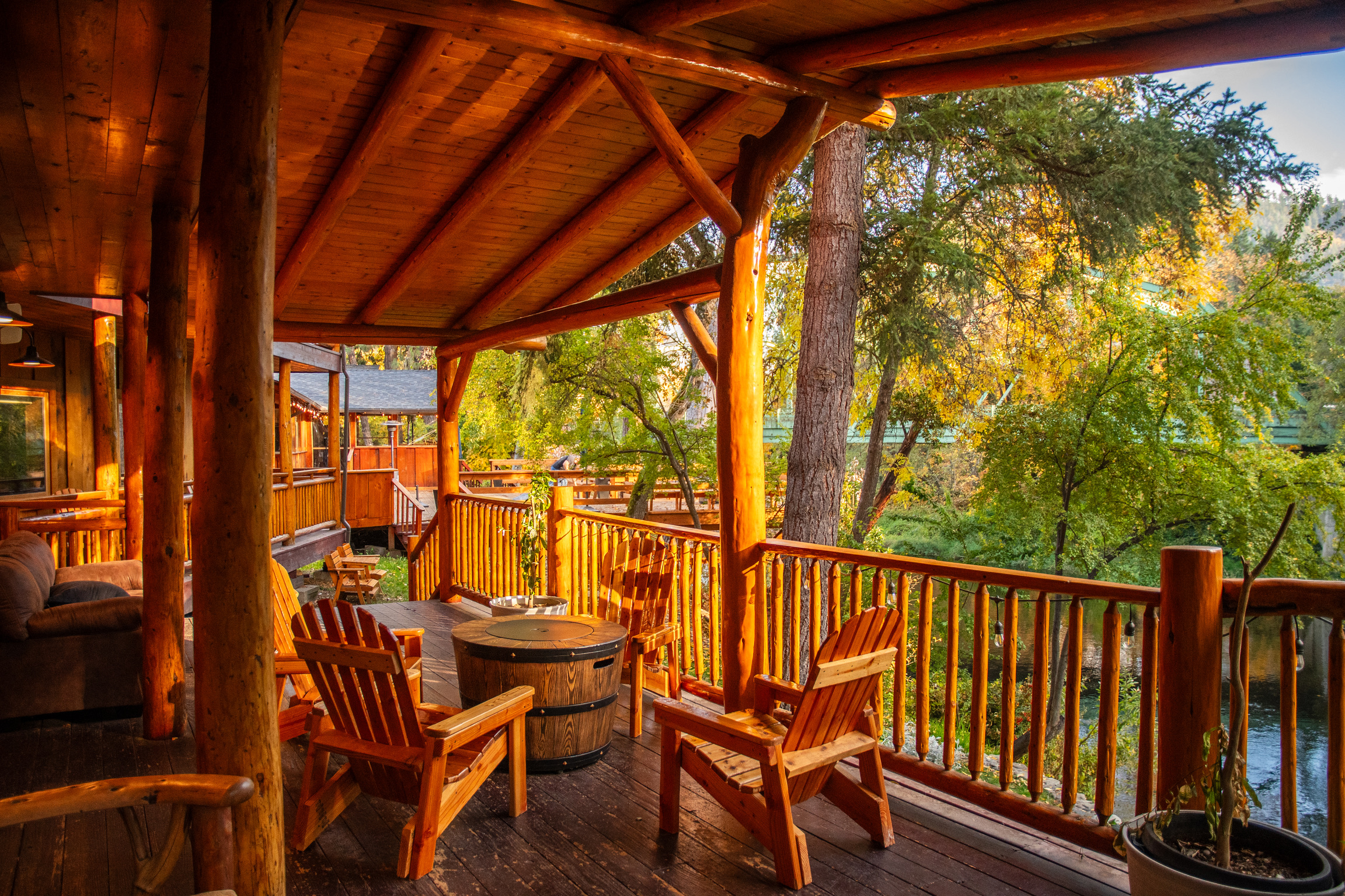 Riverfront deck with Adirondack chairs and fire pit