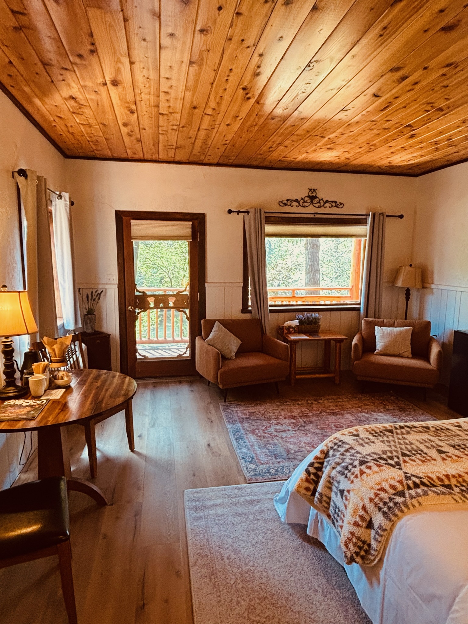 Lodge room with wood ceiling, sitting area and balcony door