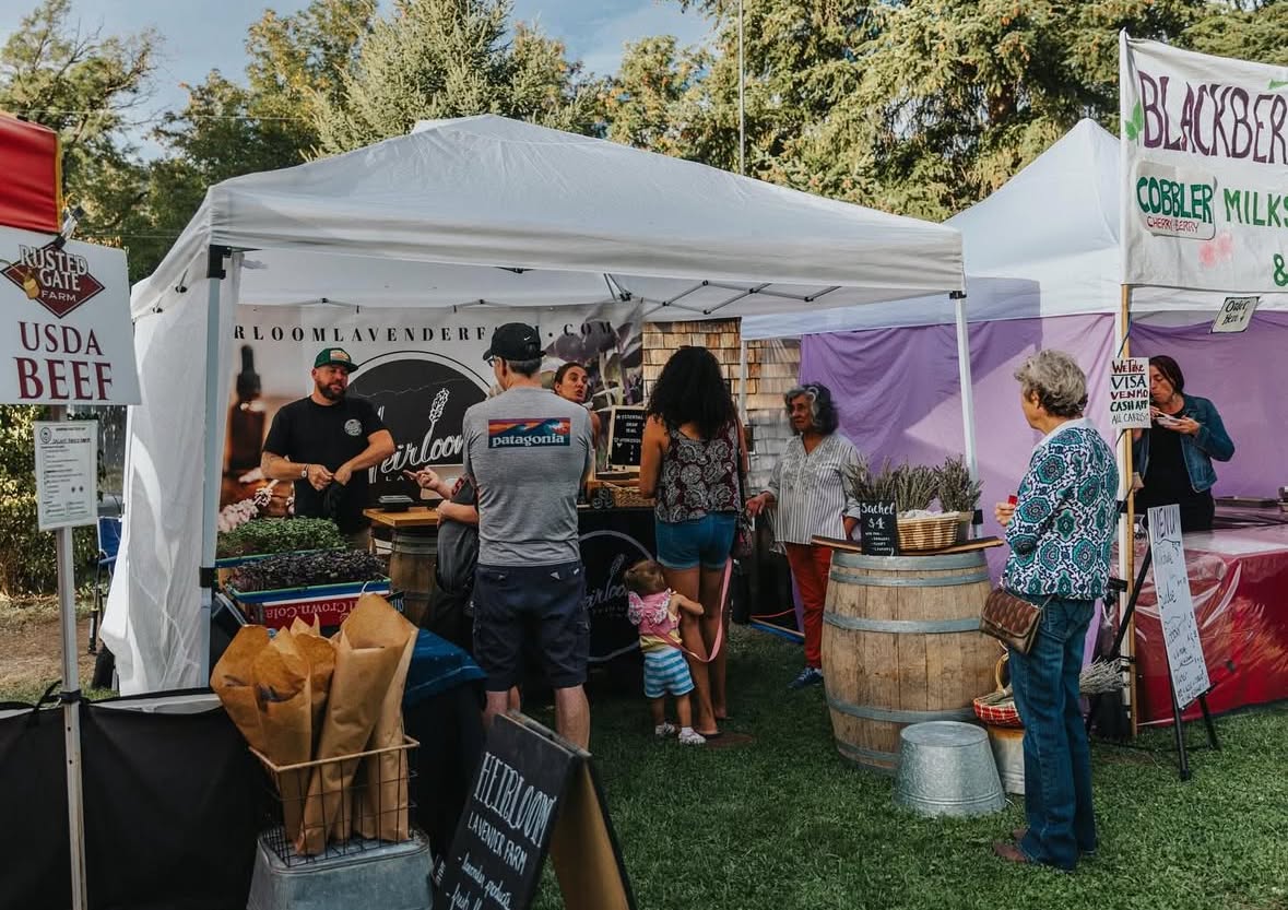 Vendor booths and crowds at the Applegate Evening Market